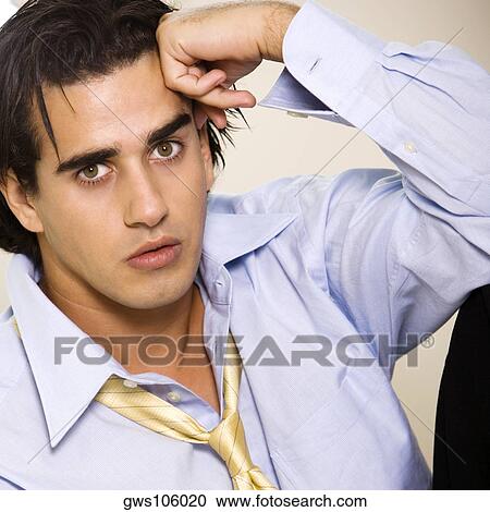Portrait of a businessman with his hand on his head View Large Photo Image Stock Image - Portrait of a businessman with his hand on his head. Fotosearch