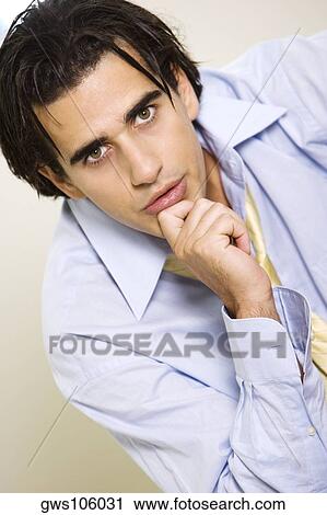Portrait of a businessman with his hand on his chin View Large Photo Image Stock Image - Portrait of a businessman with his hand on his chin. Fotosearch