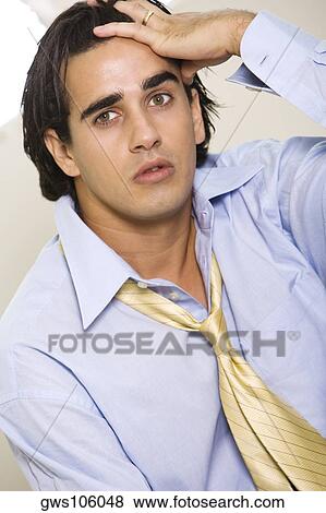 Portrait of a businessman with his hand on his head View Large Photo Image Stock Photo - Portrait of a businessman with his hand on his head. Fotosearch