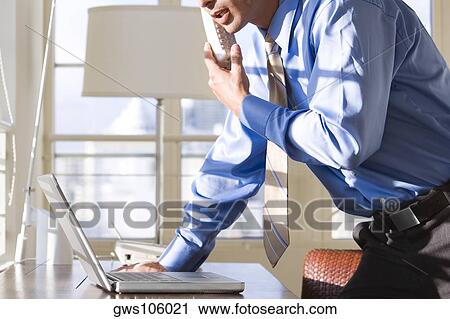 Side profile of businessman talking on a cordless phone View Large Photo Image Stock Image - Side profile of businessman talking on a cordless phone. Fotosearch