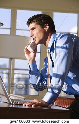Side profile of businessman talking on a cordless phone View Large Photo Image Stock Image - Side profile of businessman talking on a cordless phone. Fotosearch
