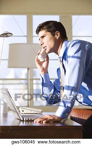 Side profile of businessman talking on a cordless phone View Large Photo Image Stock Photography - Side profile of businessman talking on a cordless phone. Fotosearch