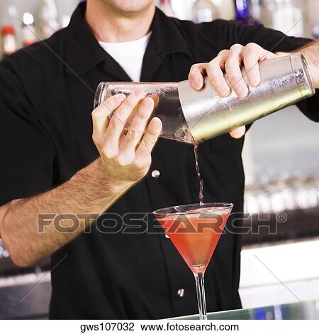 Bartender preparing a martini View Large Photo Image Stock Image - Bartender preparing a martini. Fotosearch