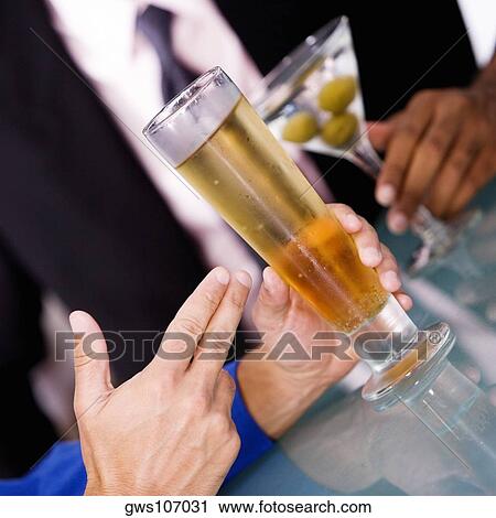 Close-up of a businessman seated at a bar counter View Large Photo Image Stock Image - Close-up of a businessman seated at a bar counter. Fotosearch