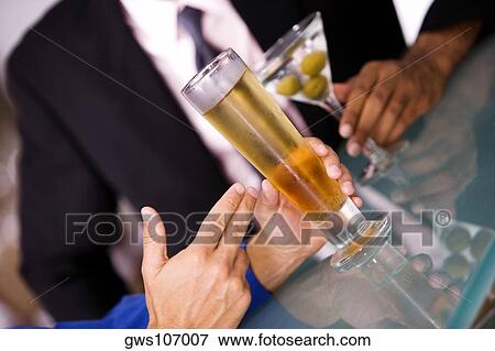 Close-up of a businessman seated at a bar counter View Large Photo Image Stock Photo - Close-up of a businessman seated at a bar counter. Fotosearch