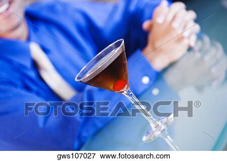 Close-up of a glass of martini on a bar counter View Large Photo Image Stock Photo - Close-up of a glass of martini on a bar counter. Fotosearch