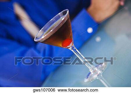 Stock Photograph - Close-up of a glass of martini on a bar counter. Fotosearch