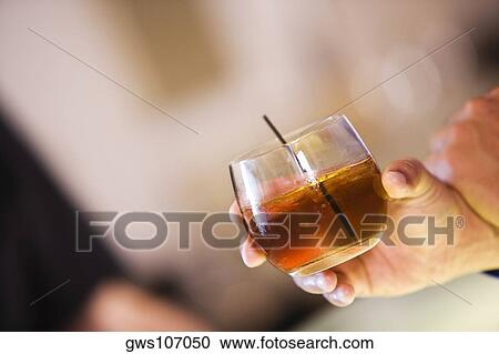 Close-up of a man's hand holding a glass View Large Photo Image Stock Image - Close-up of a man's hand holding a glass. Fotosearch