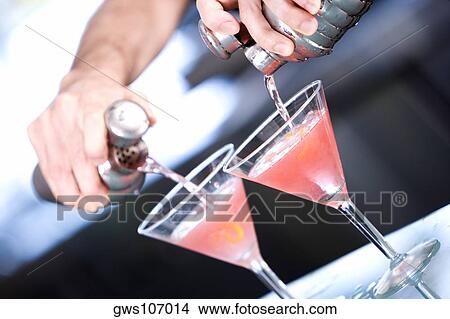Close-up of a person's hand preparing a cocktail View Large Photo Image Picture - Close-up of a person's hand preparing a cocktail. Fotosearch