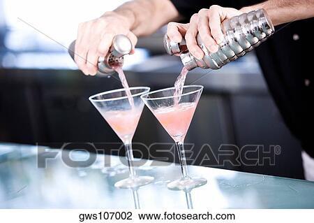 Close-up of a person's hand preparing a cocktail View Large Photo Image Stock Image - Close-up of a person's hand preparing a cocktail. Fotosearch