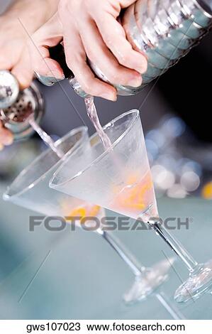 Close-up of a person's hand preparing a cocktail View Large Photo Image Stock Image - Close-up of a person's hand preparing a cocktail. Fotosearch
