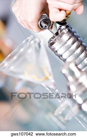 Close-up of a person's hand preparing a cocktail View Large Photo Image Stock Image - Close-up of a person's hand preparing a cocktail. Fotosearch