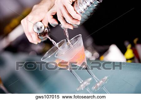 Close-up of a person's hand preparing a cocktail View Large Photo Image Stock Photography - Close-up of a person's hand preparing a cocktail. Fotosearch