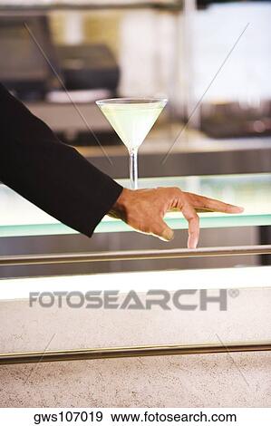 Glass of martini on the table View Large Photo Image Stock Photo - Glass of martini on the table. Fotosearch
