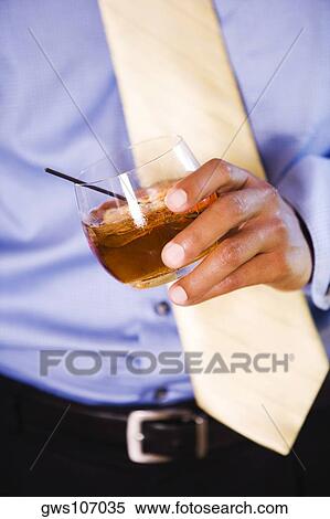 Mid section view of a businessman holding a glass of wine View Large Photo Image Stock Photography - Mid section view of a businessman holding a glass of wine. Fotosearch