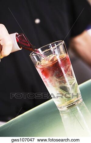Mid section view of a man preparing a cocktail View Large Photo Image Stock Photo - Mid section view of a man preparing a cocktail. Fotosearch