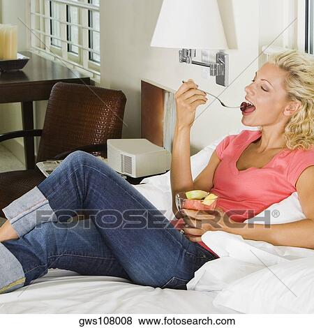High angle view of a young woman eating fruit salad View Large Photo Image Stock Photo - High angle view of a young woman eating fruit salad. Fotosearch