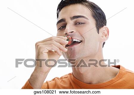 Portrait of a mid adult man eating a chocolate dipped strawberry View Large Photo Image Stock Image - Portrait of a mid adult man eating a chocolate dipped strawberry. Fotosearch