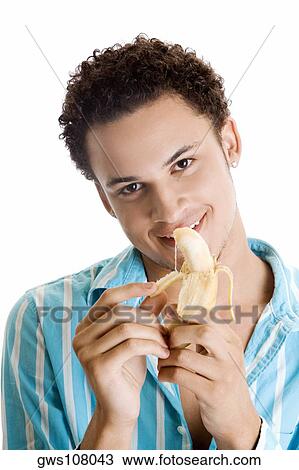 Portrait of a young man peeling a banana View Large Photo Image Stock Image - Portrait of a young man peeling a banana. Fotosearch