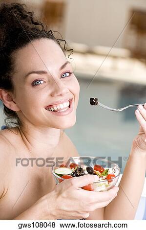 Portrait of a young woman holding a bowl of salad View Large Photo Image Stock Photo - Portrait of a young woman holding a bowl of salad. Fotosearch