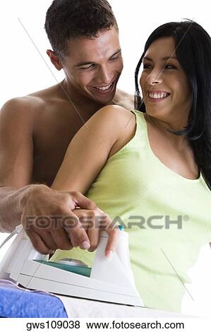 Close-up of a young couple ironing on an ironing board View Large Photo Image Stock Photo - Close-up of a young couple ironing on an ironing board. Fotosearch
