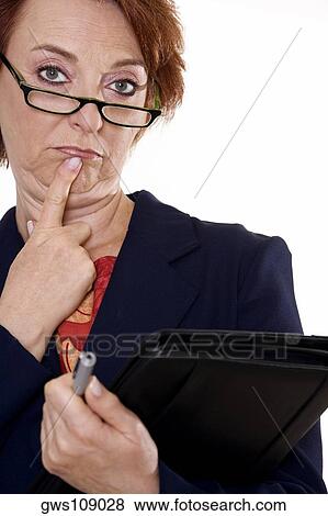 Stock Photo - Portrait of a businesswoman holding a file and a pen. Fotosearch