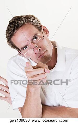 Portrait of a young man pointing forward View Large Photo Image Stock Photograph - Portrait of a young man pointing forward. Fotosearch