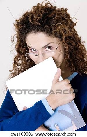 Portrait of a young woman holding a file View Large Photo Image Stock Photography - Portrait of a young woman holding a file. Fotosearch