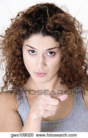 Portrait of a young woman pointing View Large Photo Image Stock Image - Portrait of a young woman pointing. Fotosearch