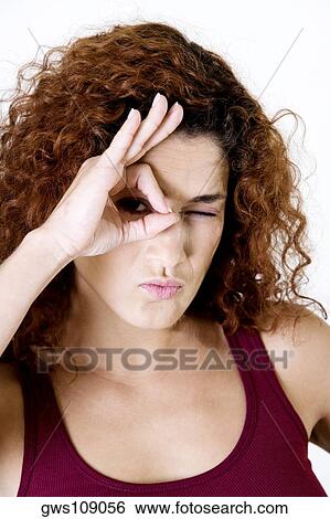 Portrait of a young woman winking View Large Photo Image Stock Photograph - Portrait of a young woman winking. Fotosearch