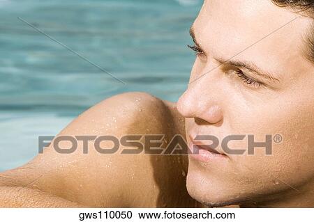 Close-up of a young man in a swimming pool View Large Photo Image Stock Image - Close-up of a young man in a swimming pool. Fotosearch