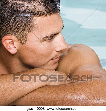 Close-up of a young man looking sideways View Large Photo Image Stock Photo - Close-up of a young man looking sideways. Fotosearch
