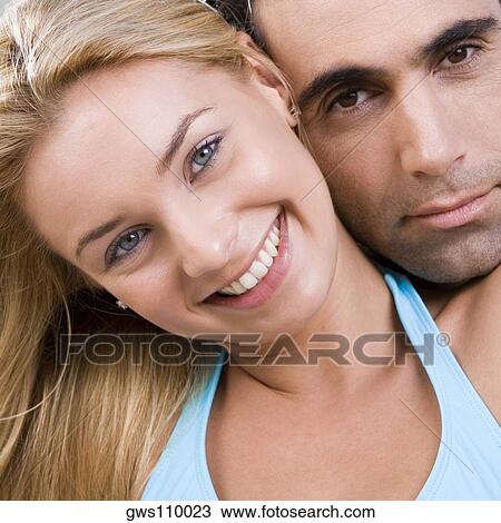 Stock Image - Portrait of a young woman and a mid adult man. Fotosearch