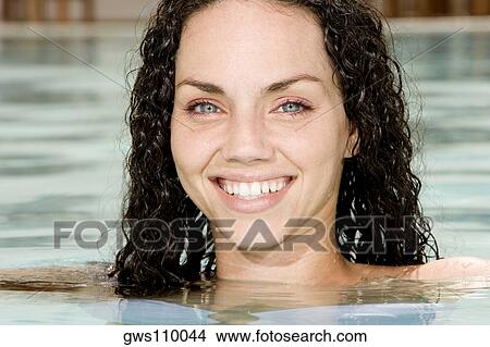 Picture - Portrait of a young woman in a swimming pool. Fotosearch