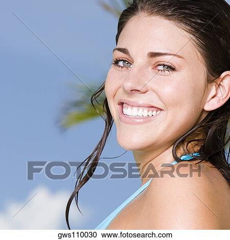 Stock Image - Portrait of a young woman smiling. Fotosearch