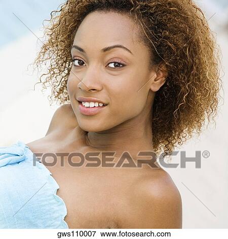 Portrait of a young woman smiling View Large Photo Image Stock Photo - Portrait of a young woman smiling. Fotosearch