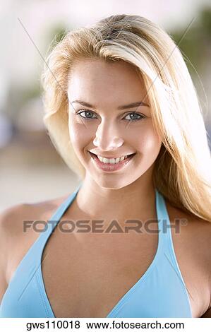 Portrait of a young woman smiling View Large Photo Image Stock Photo - Portrait of a young woman smiling. Fotosearch