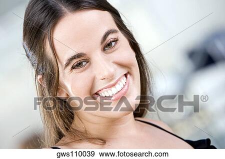 Stock Photo - Portrait of a young woman smiling. Fotosearch