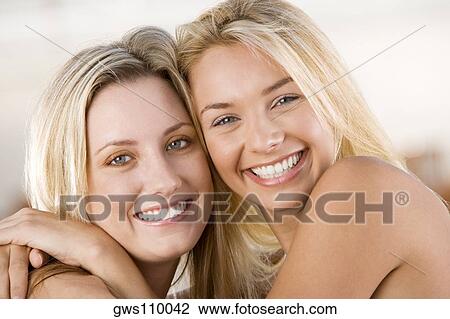 Portrait of two young women smiling View Large Photo Image Stock Image - Portrait of two young women smiling. Fotosearch