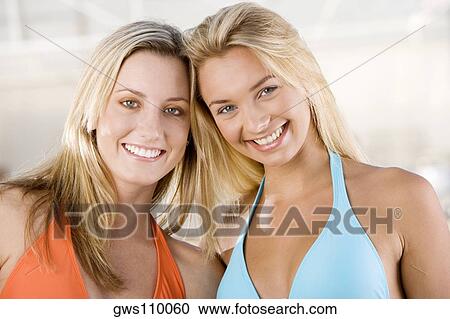 Portrait of two young women smiling View Large Photo Image Stock Image - Portrait of two young women smiling. Fotosearch