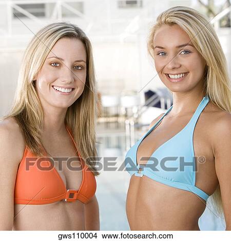 Portrait of two young women standing at the poolside View Large Photo Image Picture - Portrait of two young women standing at the poolside. Fotosearch
