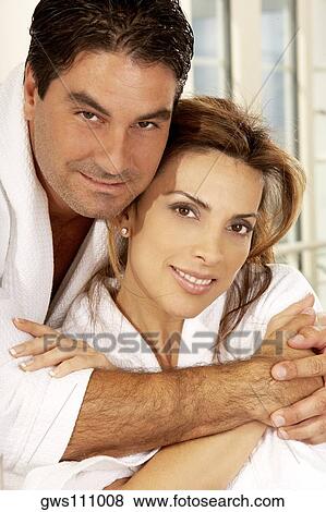 Stock Photo - Portrait of a mid adult man embracing a mid adult woman. Fotosearch