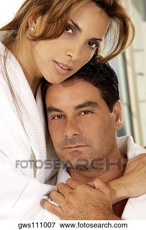 Portrait of a mid adult woman embracing a mid adult man View Large Photo Image Stock Photo - Portrait of a mid adult woman embracing a mid adult man. Fotosearch