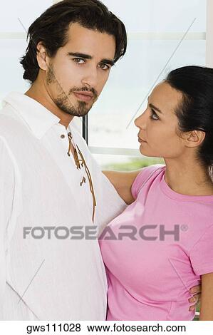 Stock Photo - Portrait of a young couple embracing each other. Fotosearch