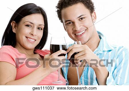 Portrait of a young couple toasting wine View Large Photo Image Stock Photo - Portrait of a young couple toasting wine. Fotosearch