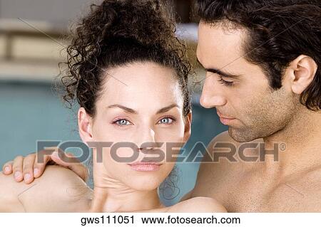 Portrait of a young woman and a mid adult man at the poolside View Large Photo Image Stock Image - Portrait of a young woman and a mid adult man at the poolside. Fotosearch