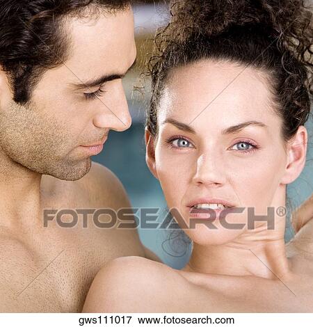 Portrait of a young woman and a mid adult man at the poolside View Large Photo Image Stock Photo - Portrait of a young woman and a mid adult man at the poolside. Fotosearch