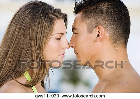 Side profile of a young couple rubbing their noses View Large Photo Image Stock Image - Side profile of a young couple rubbing their noses. Fotosearch