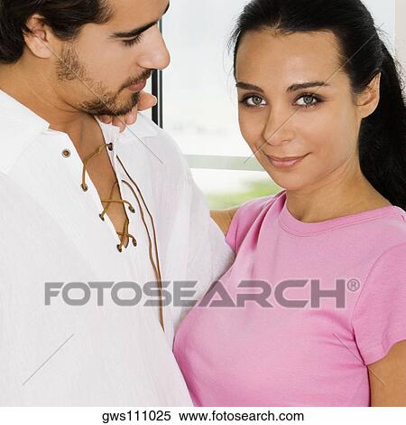 Side profile of a young couple embracing each other View Large Photo Image Stock Photography - Side profile of a young couple embracing each other. Fotosearch