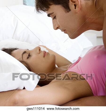 Side profile of a young man lying on top of a young woman View Large Photo Image Picture - Side profile of a young man lying on top of a young woman. Fotosearch